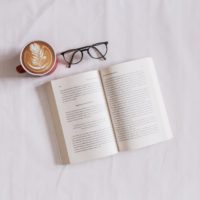 book near eyeglasses and cappuccino